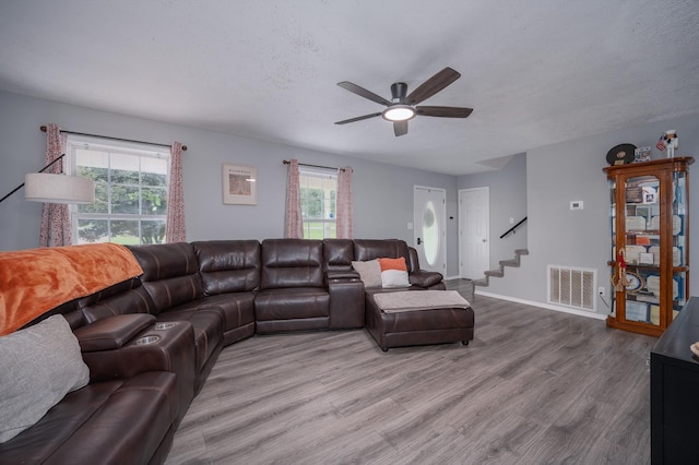 115 Pin Oaks Ln, Hohenwald, TN 38462 - living room with ceiling fan, wood finished floors, stairs, and plenty of natural light