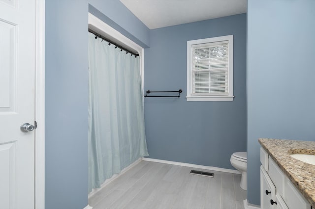 115 Pin Oaks Ln, Hohenwald, TN 38462 - bathroom featuring vanity, toilet, baseboards, wood finished floors, and a shower with shower curtain