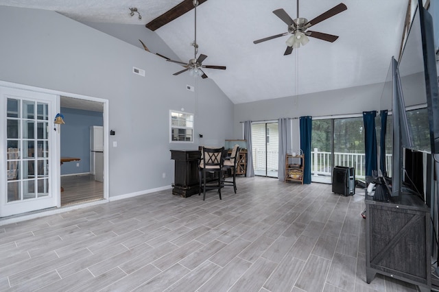 115 Pin Oaks Ln, Hohenwald, TN 38462 - living room with high vaulted ceiling, baseboards, a ceiling fan, beamed ceiling, and light wood-style flooring