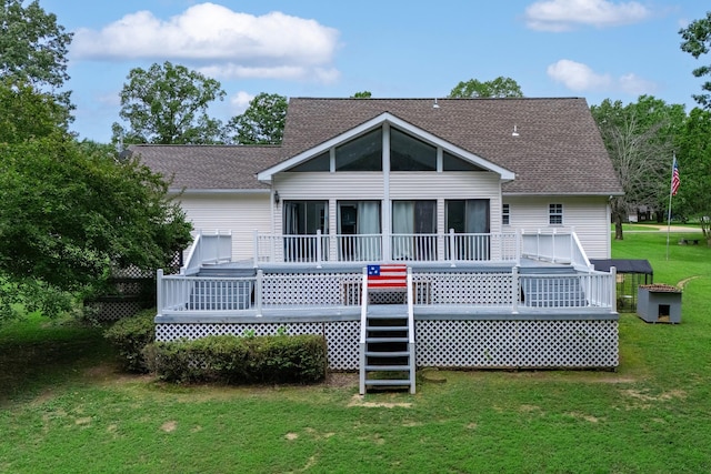 115 Pin Oaks Ln, Hohenwald, TN 38462 - back of property with a sunroom, a deck, a lawn, and roof with shingles