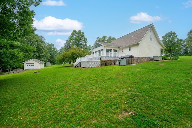 115 Pin Oaks Ln, Hohenwald, TN 38462 - back of property with an outdoor structure, a lawn, a garage, and a wooden deck