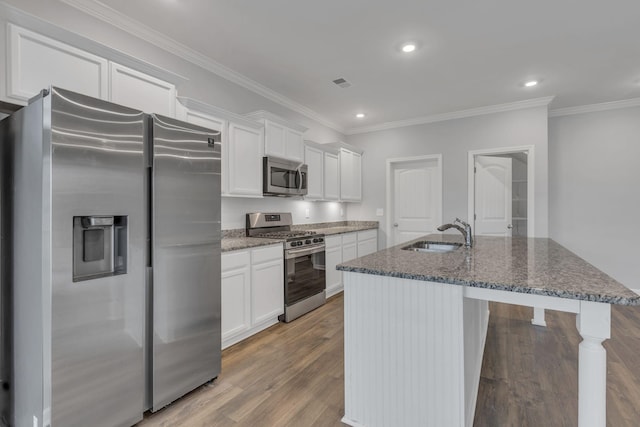 4015 Brazelton Way, Fairview, TN 37062 - kitchen with stainless steel appliances, a sink, a center island with sink, white cabinetry, and ornamental molding