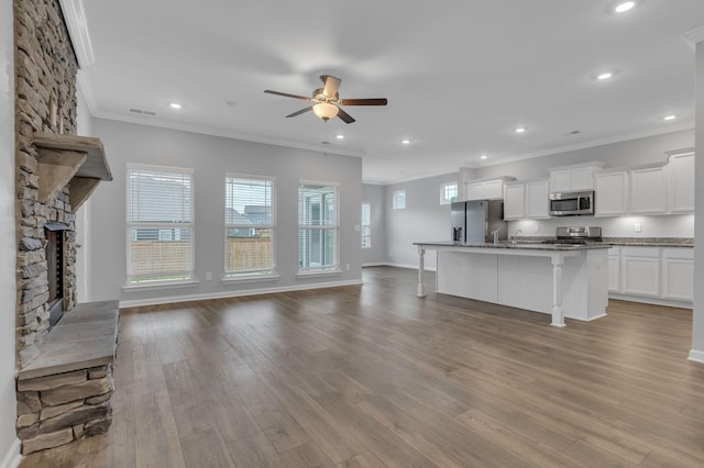 4015 Brazelton Way, Fairview, TN 37062 - unfurnished living room featuring ceiling fan, a fireplace, crown molding, wood finished floors, and recessed lighting
