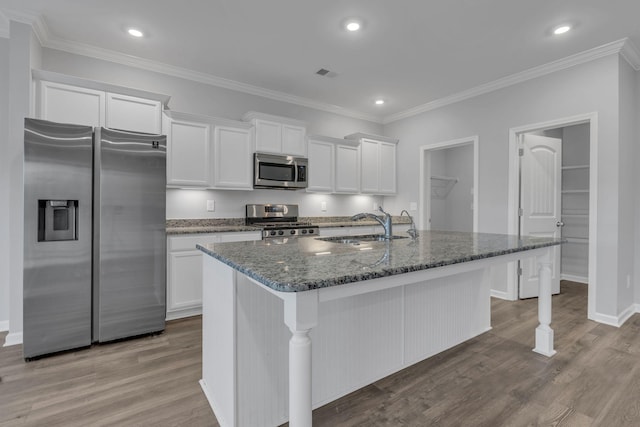 4015 Brazelton Way, Fairview, TN 37062 - kitchen with stainless steel appliances, a sink, white cabinetry, a center island with sink, and dark stone counters