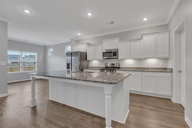 4015 Brazelton Way, Fairview, TN 37062 - kitchen with stainless steel appliances, a kitchen island with sink, a kitchen breakfast bar, white cabinets, and dark wood-type flooring