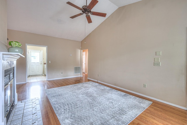 302 Laurel Hill Dr, Old Hickory, TN 37138 - unfurnished living room featuring high vaulted ceiling, ceiling fan, light wood-style floors, baseboards, and a fireplace