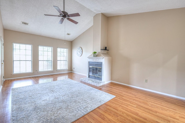 302 Laurel Hill Dr, Old Hickory, TN 37138 - unfurnished living room with light wood finished floors, baseboards, ceiling fan, a textured ceiling, and a glass covered fireplace