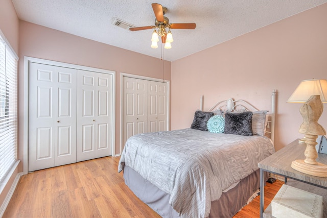 302 Laurel Hill Dr, Old Hickory, TN 37138 - bedroom with two closets, wood finished floors, a textured ceiling, and ceiling fan