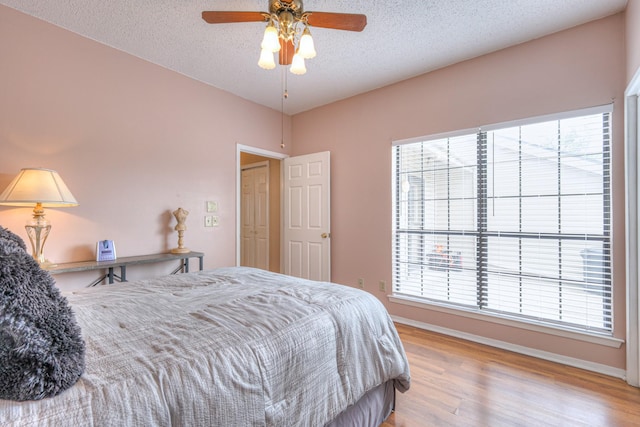 302 Laurel Hill Dr, Old Hickory, TN 37138 - bedroom featuring wood finished floors, a textured ceiling, baseboards, and a ceiling fan