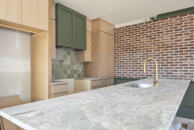 1701 Portland Ave Unit E, Nashville, TN 37212 - kitchen featuring a sink, tasteful backsplash, light stone counters, and light brown cabinets