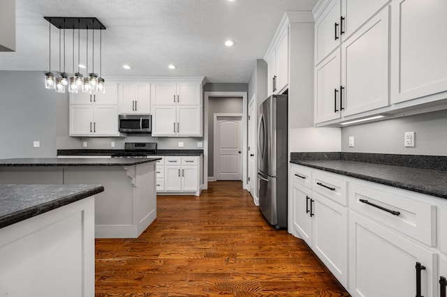 167 Lancaster St, Hillsboro, TN 37342 - kitchen with appliances with stainless steel finishes, dark wood-style flooring, recessed lighting, white cabinets, and a textured ceiling