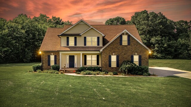 167 Lancaster St, Hillsboro, TN 37342 - view of front facade with a yard, brick siding, and a shingled roof