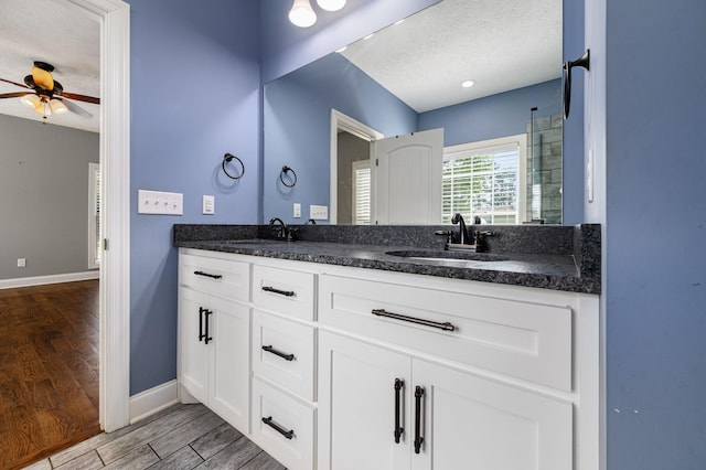 167 Lancaster St, Hillsboro, TN 37342 - full bathroom featuring a textured ceiling, double vanity, baseboards, ceiling fan, and wood finished floors