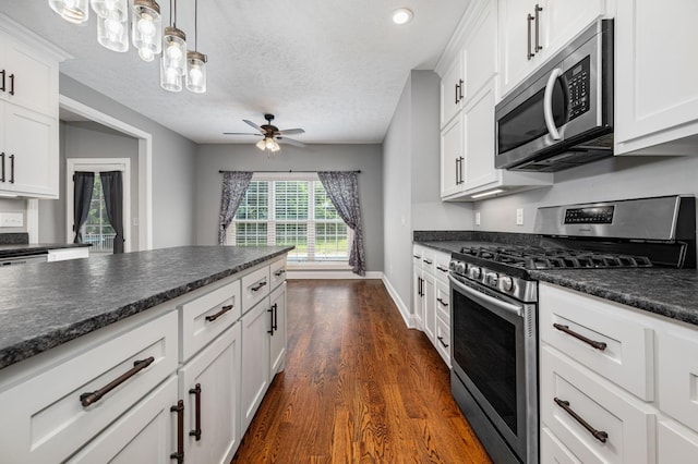 167 Lancaster St, Hillsboro, TN 37342 - kitchen featuring stainless steel appliances, dark countertops, dark wood-type flooring, ceiling fan, and white cabinetry