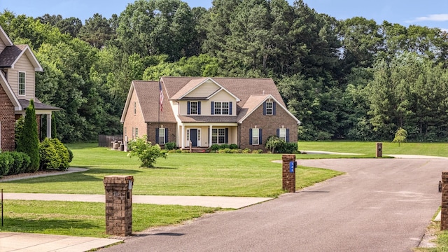 167 Lancaster St, Hillsboro, TN 37342 - traditional-style house with brick siding, a front yard, and covered porch