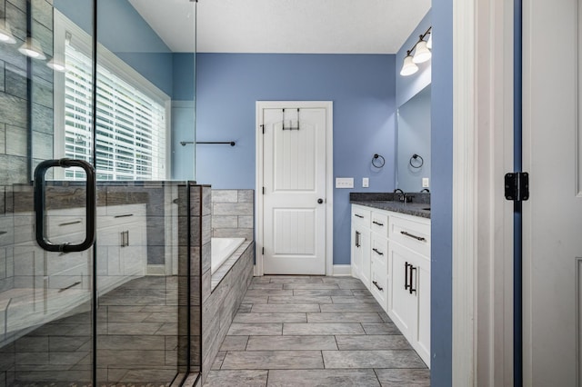 167 Lancaster St, Hillsboro, TN 37342 - bathroom featuring vanity, a bath, a stall shower, and baseboards
