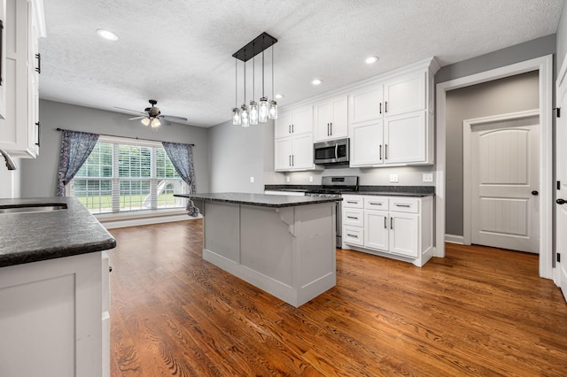 167 Lancaster St, Hillsboro, TN 37342 - kitchen featuring appliances with stainless steel finishes, a textured ceiling, ceiling fan, white cabinets, and dark wood-type flooring