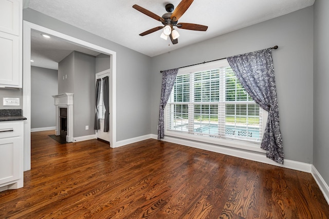 167 Lancaster St, Hillsboro, TN 37342 - unfurnished living room featuring ceiling fan, baseboards, dark wood-style floors, a fireplace with flush hearth, and recessed lighting