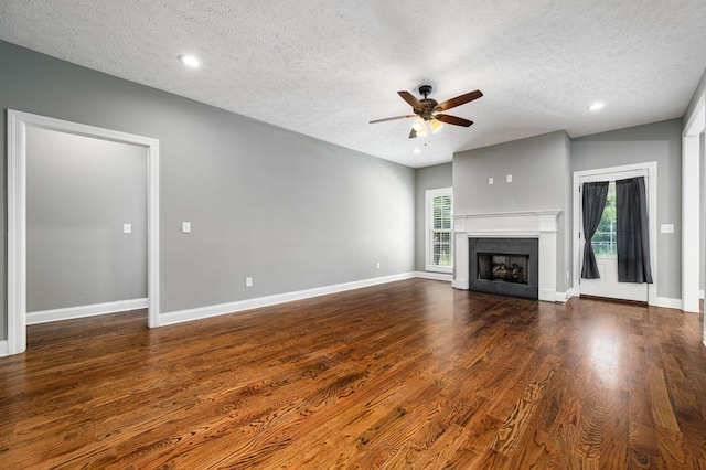 167 Lancaster St, Hillsboro, TN 37342 - unfurnished living room featuring a textured ceiling, ceiling fan, dark wood-style flooring, baseboards, and a fireplace