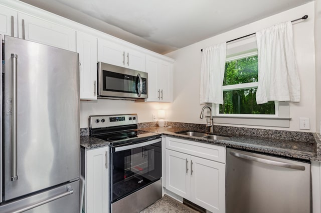 349 Dawn Dr, Cedar Hill, TN 37032 - kitchen featuring appliances with stainless steel finishes, a sink, white cabinetry, and dark stone countertops