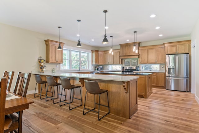 2825 Oregon Rd, Milton, TN 37118 - kitchen with stainless steel appliances, a peninsula, light wood-type flooring, a kitchen bar, and recessed lighting