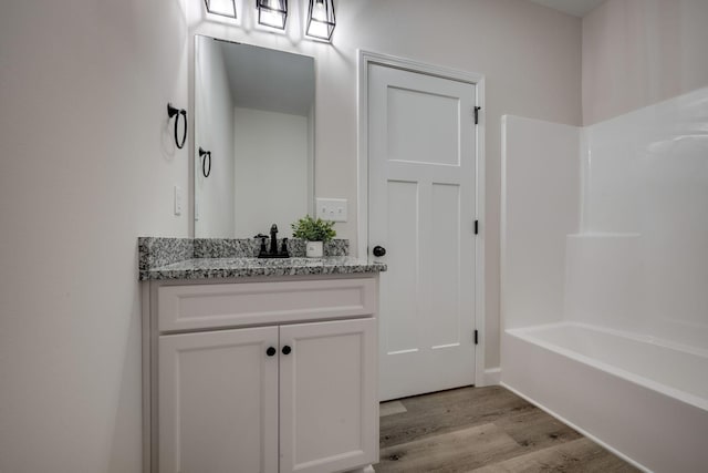 1502 Rock Springs Rd, Cumberland Furnace, TN 37051 - full bathroom with wood finished floors, vanity, and washtub / shower combination