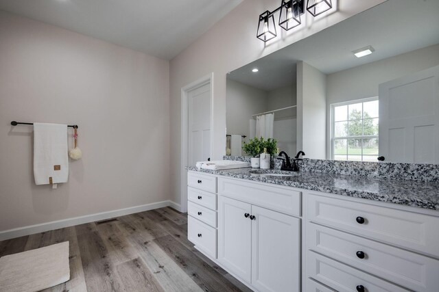 1502 Rock Springs Rd, Cumberland Furnace, TN 37051 - full bath with double vanity, wood finished floors, baseboards, and a shower with shower curtain