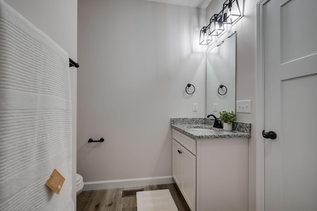1502 Rock Springs Rd, Cumberland Furnace, TN 37051 - bathroom featuring wood finished floors, vanity, toilet, and baseboards