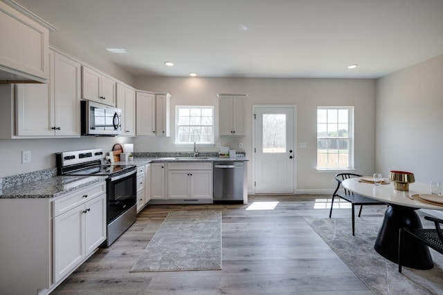 1502 Rock Springs Rd, Cumberland Furnace, TN 37051 - kitchen featuring appliances with stainless steel finishes, a sink, healthy amount of natural light, recessed lighting, and light stone counters