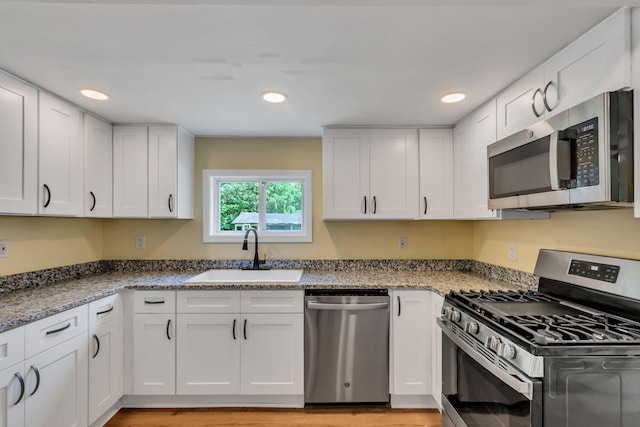 325 Francis Rd, Decherd, TN 37324 - kitchen with stainless steel appliances, a sink, white cabinets, stone countertops, and recessed lighting
