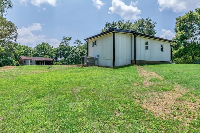 325 Francis Rd, Decherd, TN 37324 - view of green lawn with central AC unit and an outbuilding
