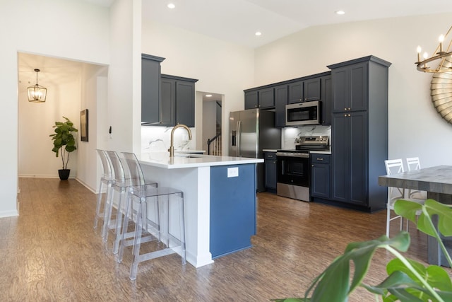 3164 Winberry Dr, Franklin, TN 37064 - kitchen with stainless steel appliances, a chandelier, a breakfast bar area, a sink, and a peninsula