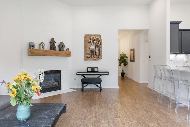 3164 Winberry Dr, Franklin, TN 37064 - living room featuring wood finished floors, a brick fireplace, baseboards, and a high ceiling