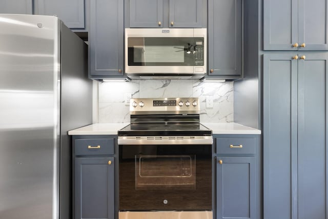 3164 Winberry Dr, Franklin, TN 37064 - kitchen with appliances with stainless steel finishes, tasteful backsplash, light countertops, gray cabinetry, and blue cabinets
