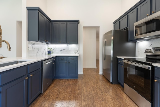 3164 Winberry Dr, Franklin, TN 37064 - kitchen featuring stainless steel appliances, a sink, dark wood finished floors, light countertops, and decorative backsplash