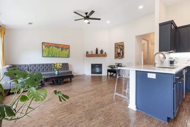 3164 Winberry Dr, Franklin, TN 37064 - kitchen featuring blue cabinetry, a sink, a breakfast bar, open floor plan, and ceiling fan