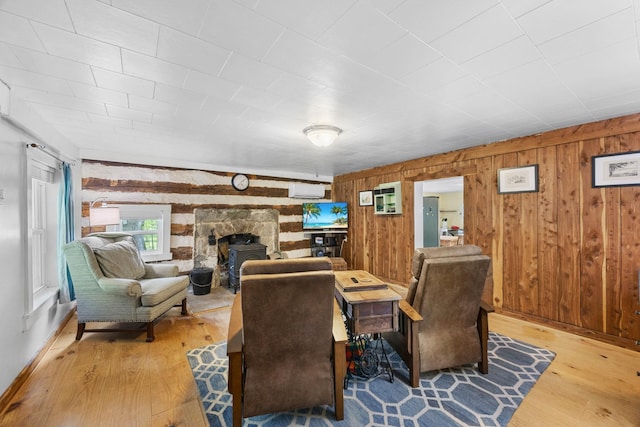 379 Gunson Ridge Rd, Cumberland City, TN 37050 - dining area with hardwood / wood-style floors, wood walls, a wall mounted air conditioner, and baseboards