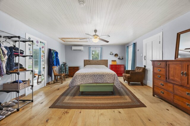 379 Gunson Ridge Rd, Cumberland City, TN 37050 - bedroom with a wall mounted AC, light wood-style floors, and ceiling fan