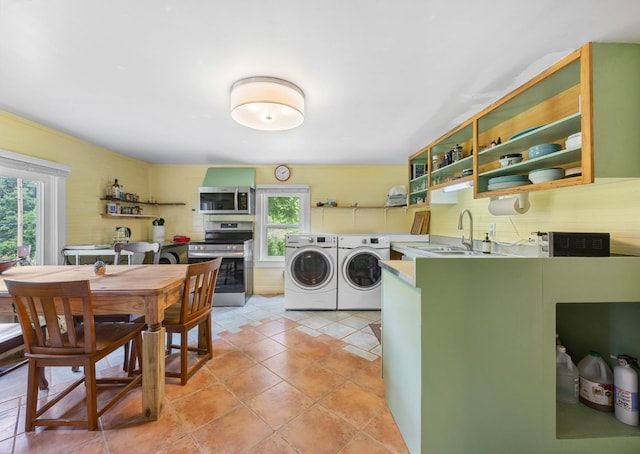 379 Gunson Ridge Rd, Cumberland City, TN 37050 - laundry area with washer and clothes dryer and light tile patterned floors