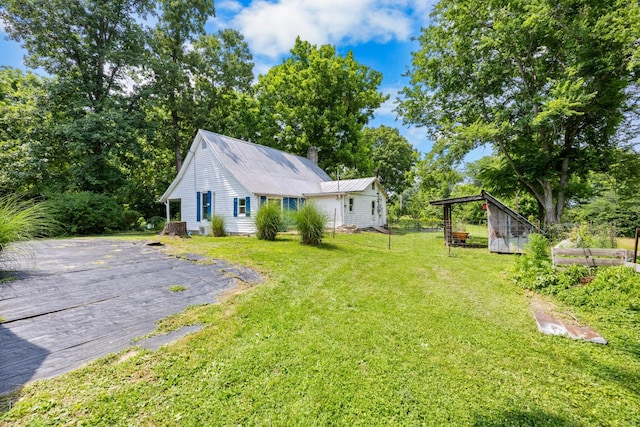 379 Gunson Ridge Rd, Cumberland City, TN 37050 - view of green lawn with asphalt driveway and an outdoor structure
