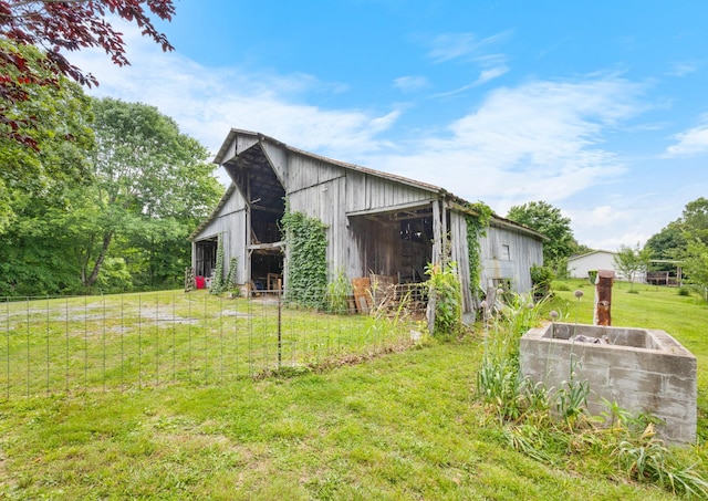379 Gunson Ridge Rd, Cumberland City, TN 37050 - view of side of home featuring a lawn and an outdoor structure