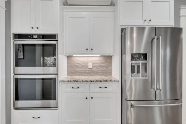 2732 Cherrydale Dr, Lebanon, TN 37087 - kitchen with stainless steel appliances, white cabinets, tasteful backsplash, and light stone countertops