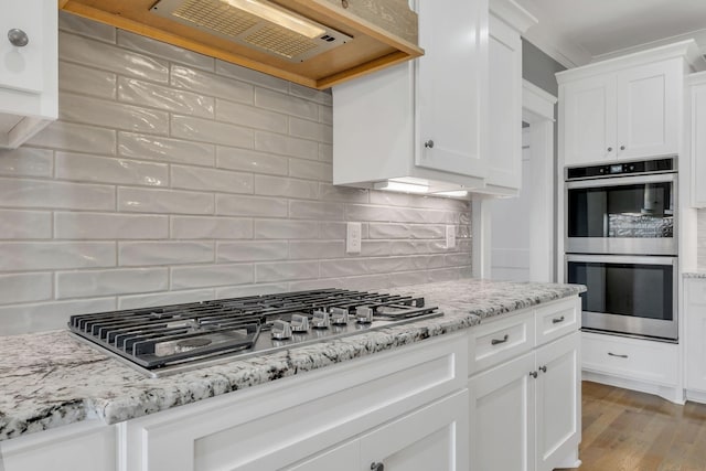 2732 Cherrydale Dr, Lebanon, TN 37087 - kitchen featuring stainless steel appliances, white cabinets, light wood-type flooring, and decorative backsplash