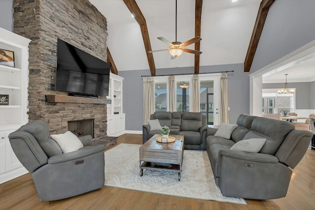2732 Cherrydale Dr, Lebanon, TN 37087 - living area with a chandelier, ceiling fan, a stone fireplace, beam ceiling, and wood finished floors