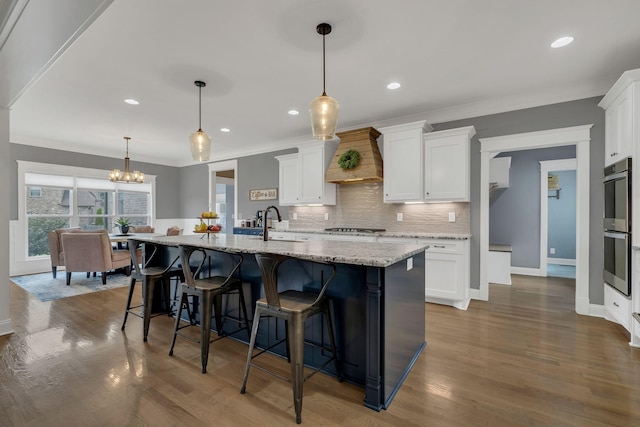 2732 Cherrydale Dr, Lebanon, TN 37087 - kitchen with double oven, white cabinets, decorative backsplash, crown molding, and recessed lighting