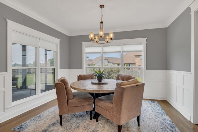 2732 Cherrydale Dr, Lebanon, TN 37087 - dining space with a chandelier, a wainscoted wall, wood finished floors, crown molding, and a decorative wall