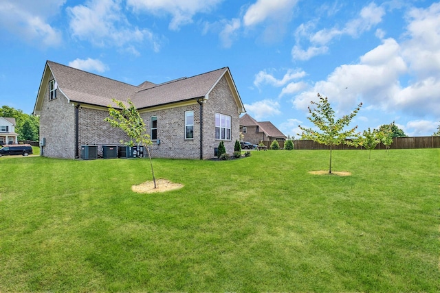 2732 Cherrydale Dr, Lebanon, TN 37087 - view of side of home with central AC unit, brick siding, and a shingled roof