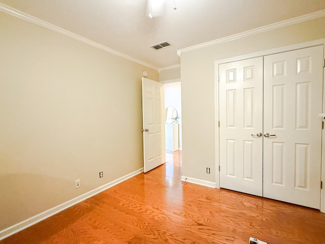 2138 Cason Ln, Murfreesboro, TN 37128 - unfurnished bedroom featuring light wood-style floors, crown molding, baseboards, and a closet