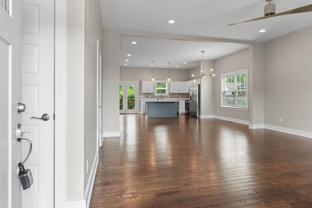 1512 Dr D B Todd Jr Blvd, Nashville, TN 37208 - unfurnished living room with dark wood-style floors, baseboards, a chandelier, a ceiling fan, and recessed lighting
