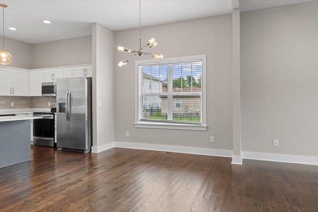 1512 Dr D B Todd Jr Blvd, Nashville, TN 37208 - kitchen with appliances with stainless steel finishes, a chandelier, light countertops, white cabinetry, and dark wood-type flooring